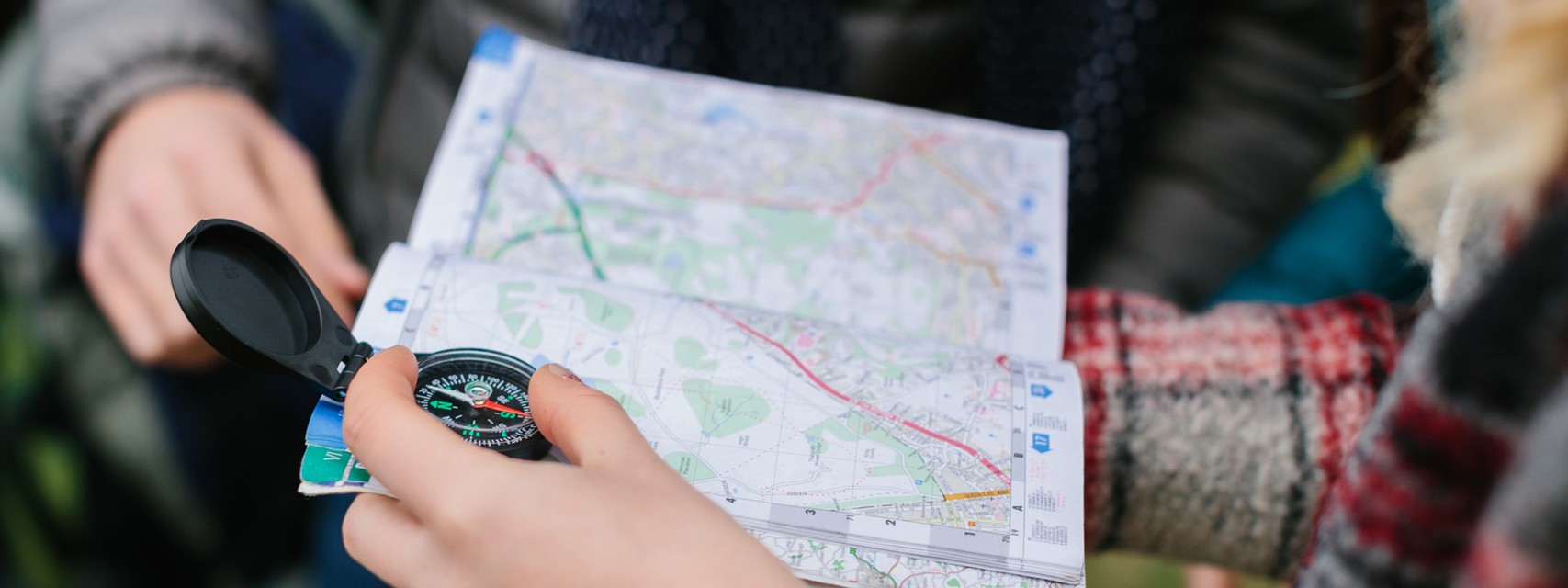 Guide looking at a compass and a map