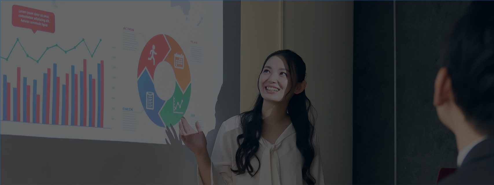 Woman pointing to slide image while presenting.
