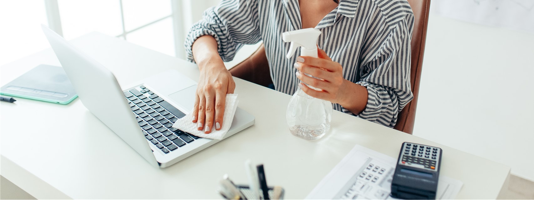 woman cleaning desk at corporate office