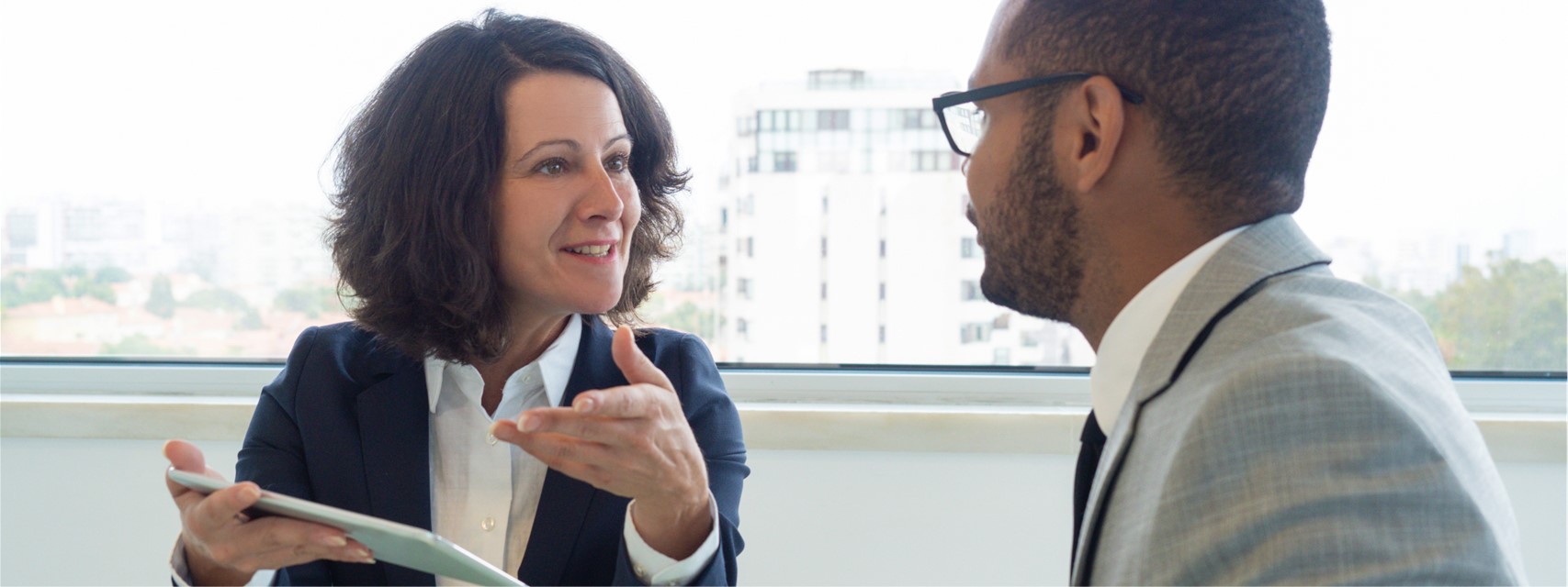 Woman explaining taxation of equity awards to employee who is moving to another state