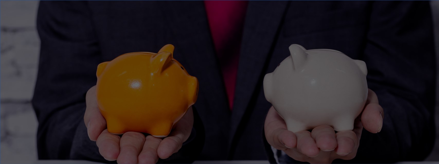 business man weighing two piggy banks above a pile of coins