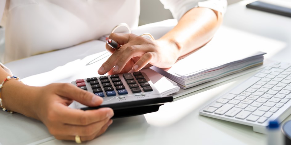 Business woman calculating tax withholding for equity award transactions