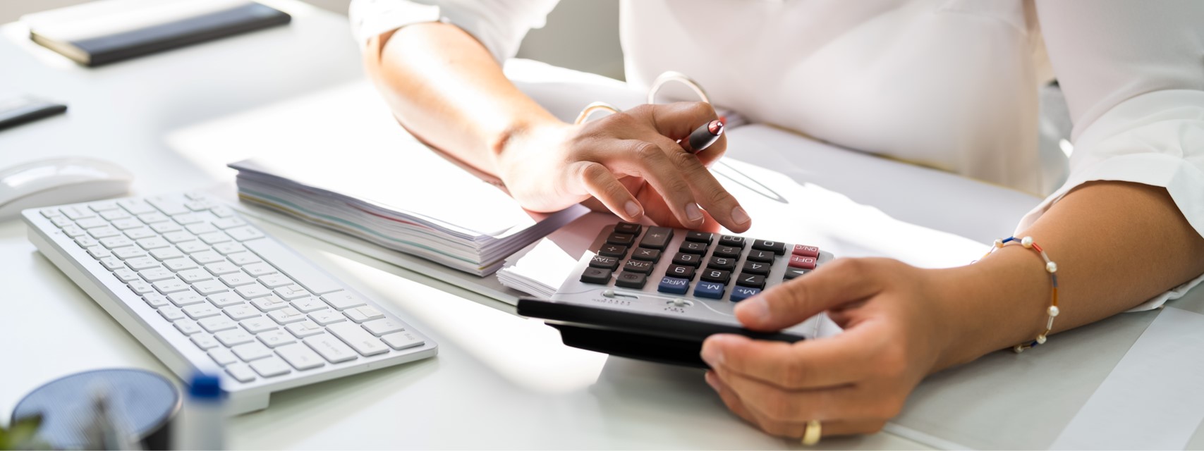 Business woman calculating tax withholding for an equity award transaction