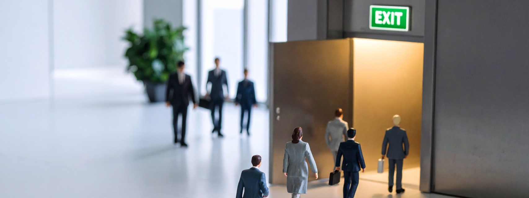 Visual metaphor for termination of employment showing employee figures leaving a building through a door marked exit