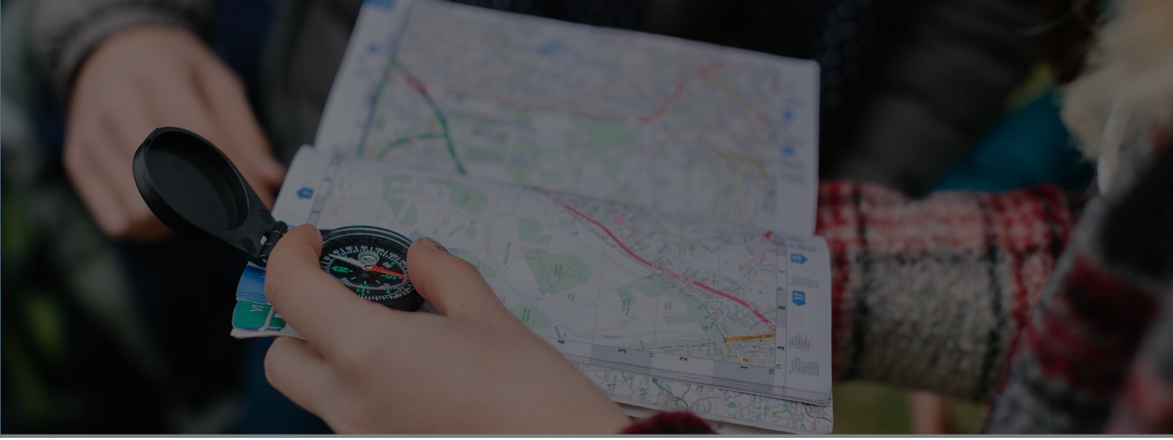 Guide looking at a compass and a map