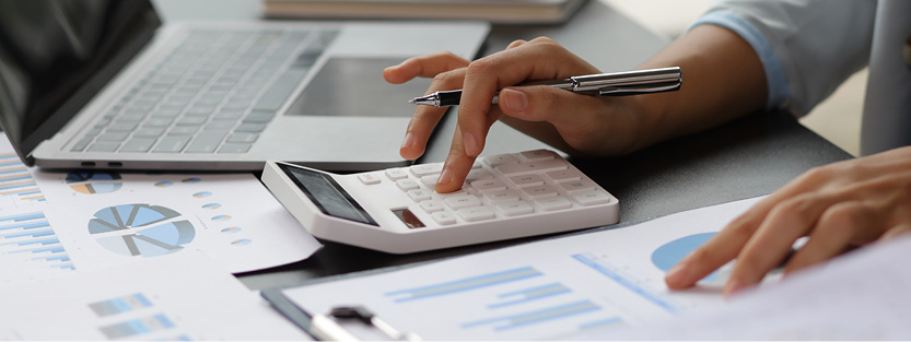 Woman working at desk making calculations