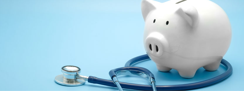 Piggy bank standing over a stethoscope
