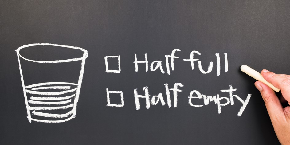 chalkboard drawing of glass half full