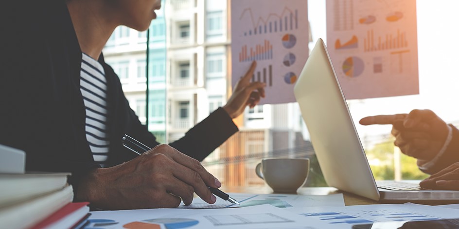 Business people discussing charts and graphs showing financial results