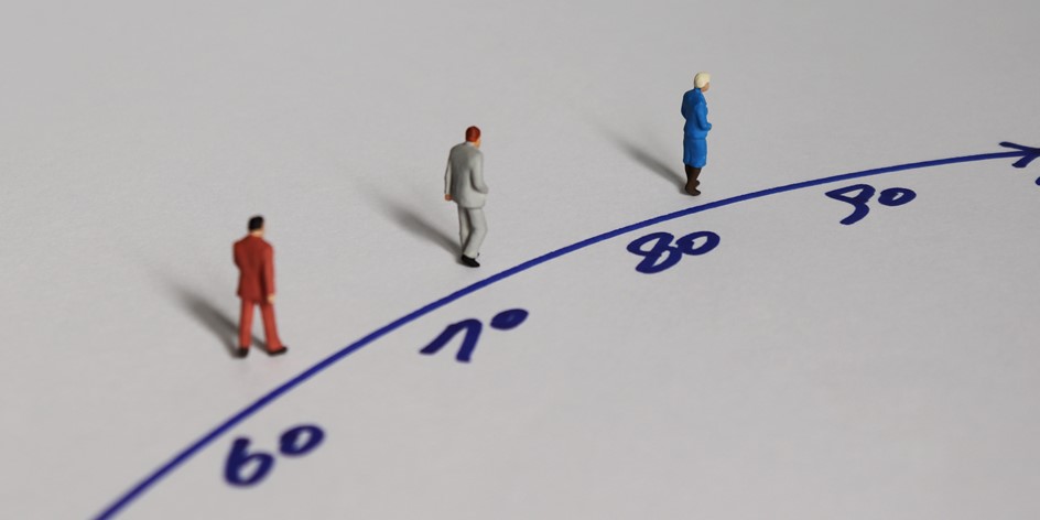 Trendline of retirement ages with toy figures for businessmen standing at each age.