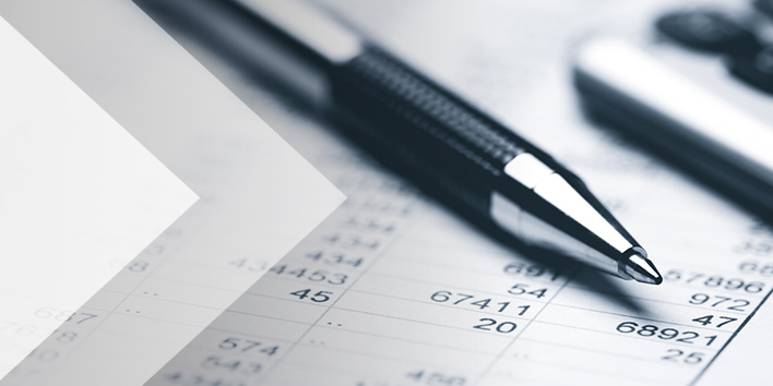 Pen and calculator sitting on top of printout of tax calculations