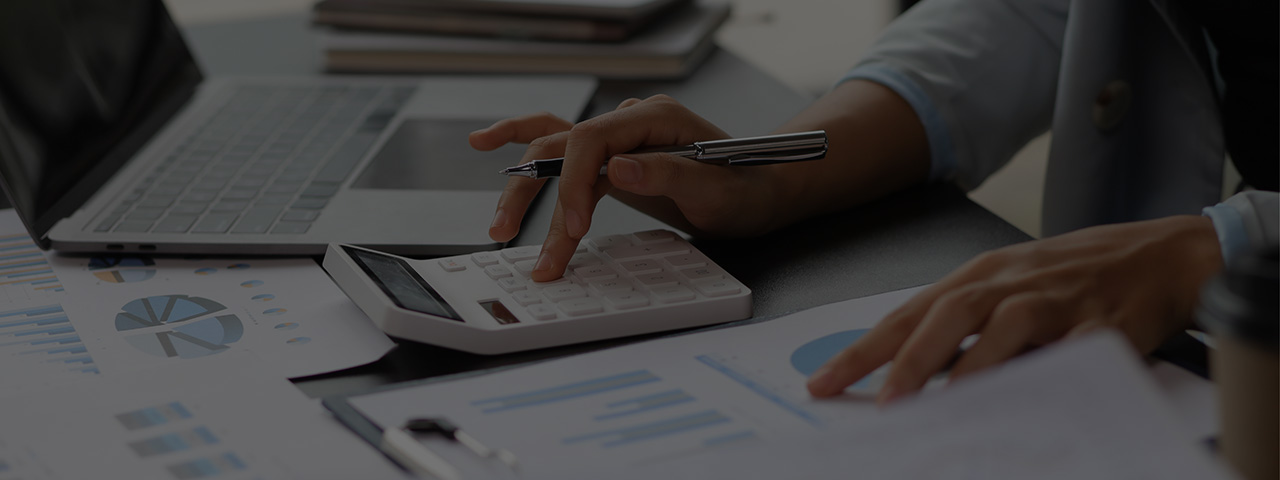 Woman working at desk making calculations