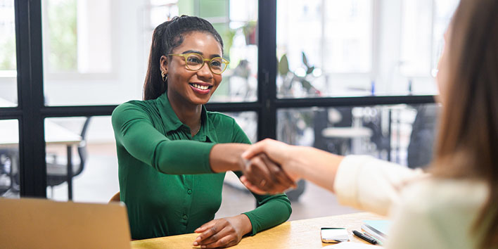 Business women shaking hands