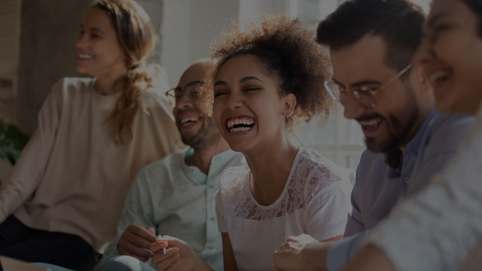 Membership Page Background Diverse group of coworkers seated together laughing