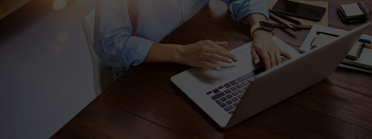 Woman writing a blog on laptop